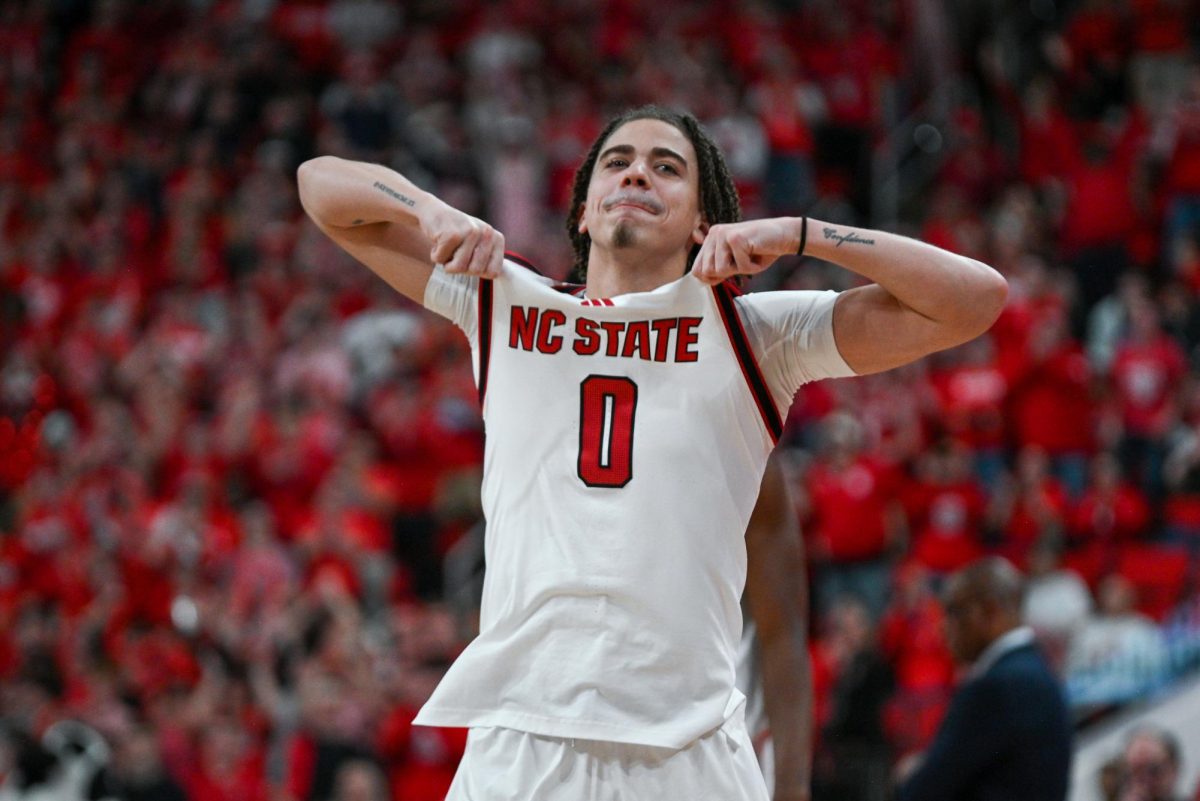Senior guard Jordan Snell hypes up the crowd as he gets subbed in during the game against North Carolina at the Lenovo Center on Tuesday, Feb. 17, 2026. The Wolfpack defeated the Tar Heels 82–58.