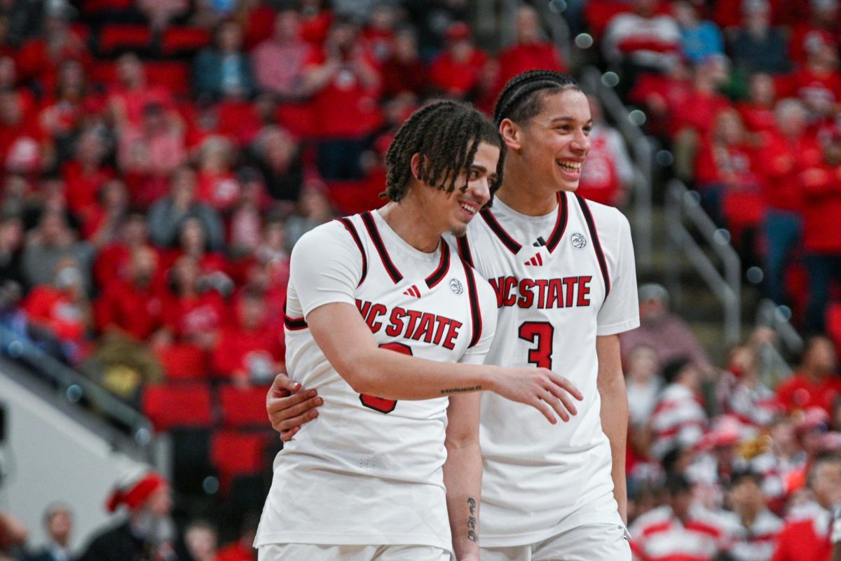 Senior guard Jordan Snell and freshman guard Matt Able laugh after receiving a technical foul during the game against North Carolina at the Lenovo Center on Tuesday, Feb. 17, 2026. The Wolfpack defeated the Tar Heels 82–58.