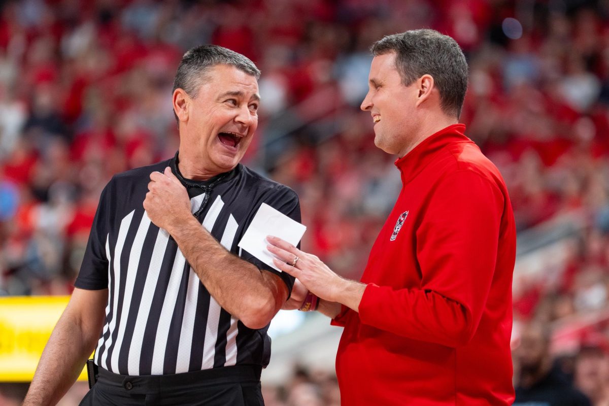 Head coach Will Wade laughs with a referee during the game against North Carolina at the Lenovo Center on Tuesday, Feb. 17, 2026. The Wolfpack defeated the Tar Heels 82–58.