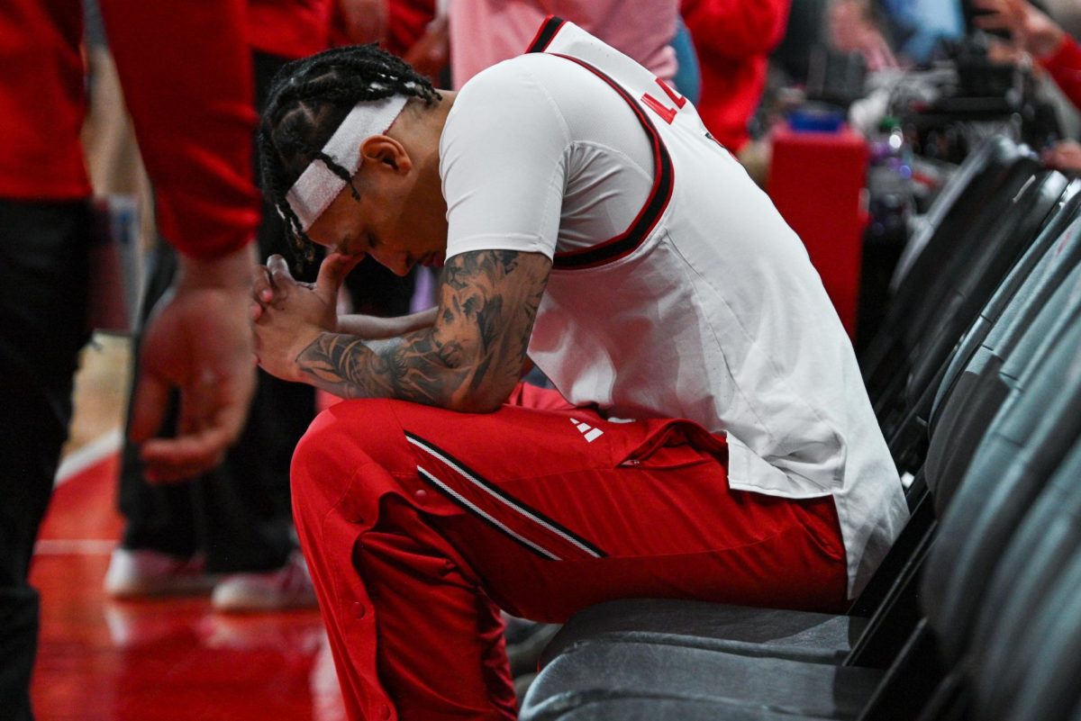 Senior forward Darrion Williams prays on the bench before the game against North Carolina at the Lenovo Center on Tuesday, Feb. 17, 2026. Williams finished with 13 points.. The Wolfpack defeated the Tar Heels 82-58.
