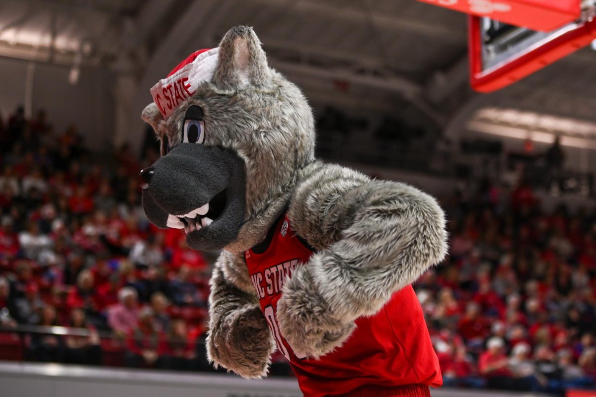 Mr. Wuf flexes during the game against Syracuse in Reynolds Coliseum on Sunday, Feb. 22, 2026. The Wolfpack defeated the Orange 82-69.