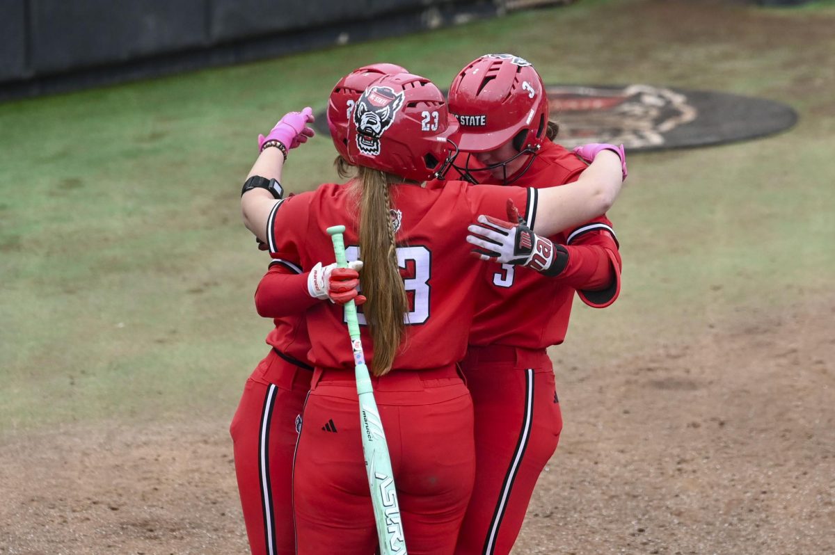Senior catcher Ellington Whitaker and senior catcher Hannah Church celebrate freshman first baseman Morgen Talley's homerun hit during the game against Illinois in Dail Softball Stadium on Sunday, Feb. 22, 2026. The Wolfpack defeated the Illini 4-0. 
