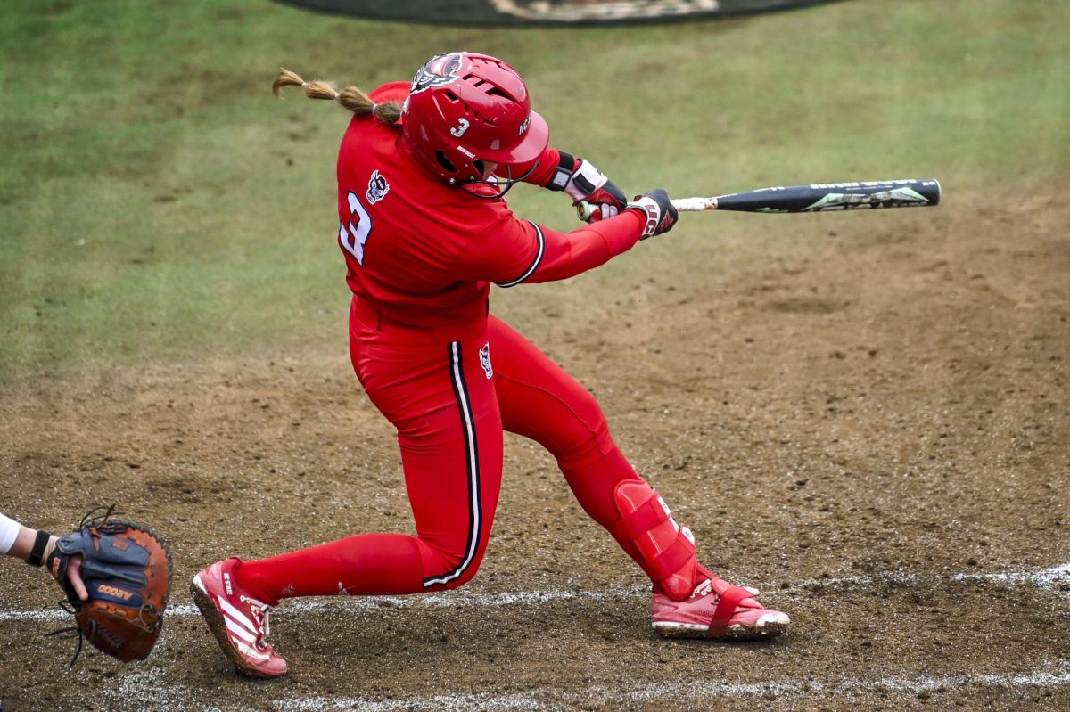 Freshman first baseman Morgen Talley hits the ball during the game against Illinois in Dail Softball Stadium on Sunday, Feb. 22, 2026. Talley had one RBI. The Wolfpack defeated the Illini 4-0. 