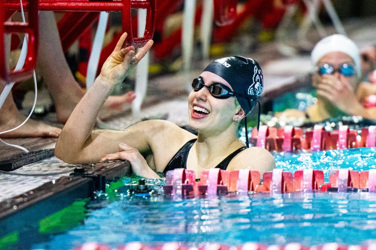 Sophomore Leah Shackley puts up a "wolfie" hand sign after competing during the meet against Virginia in the Casey Aquatic Center on Friday, Jan. 23, 2026. NC State Women lose to Virginia 181-113