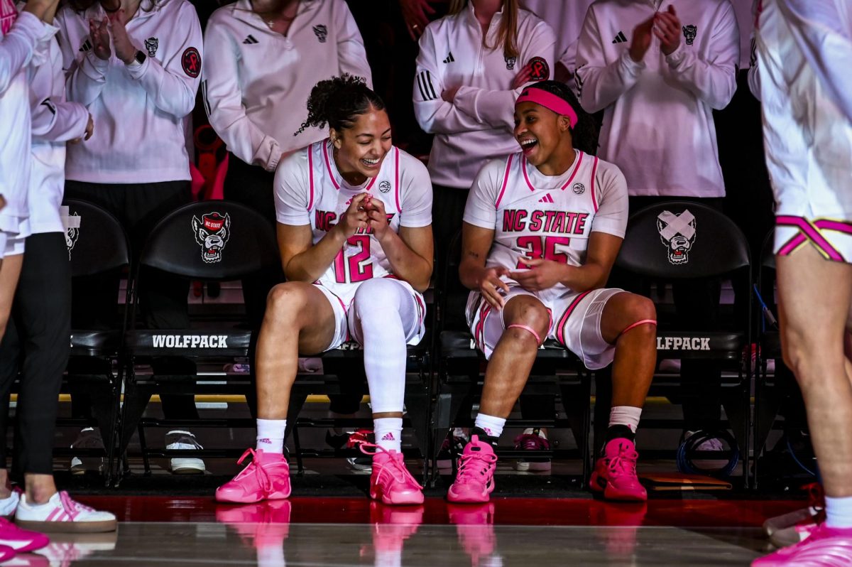 Junior forward Khamil Pierre and Junior guard Zoe Brooks laugh together before the Play4Kay game against UNC-Chapel Hill at Reynolds Coliseum on Monday, Feb. 2, 2026. The Tar Heels defeated the Wolfpack 61-59. 