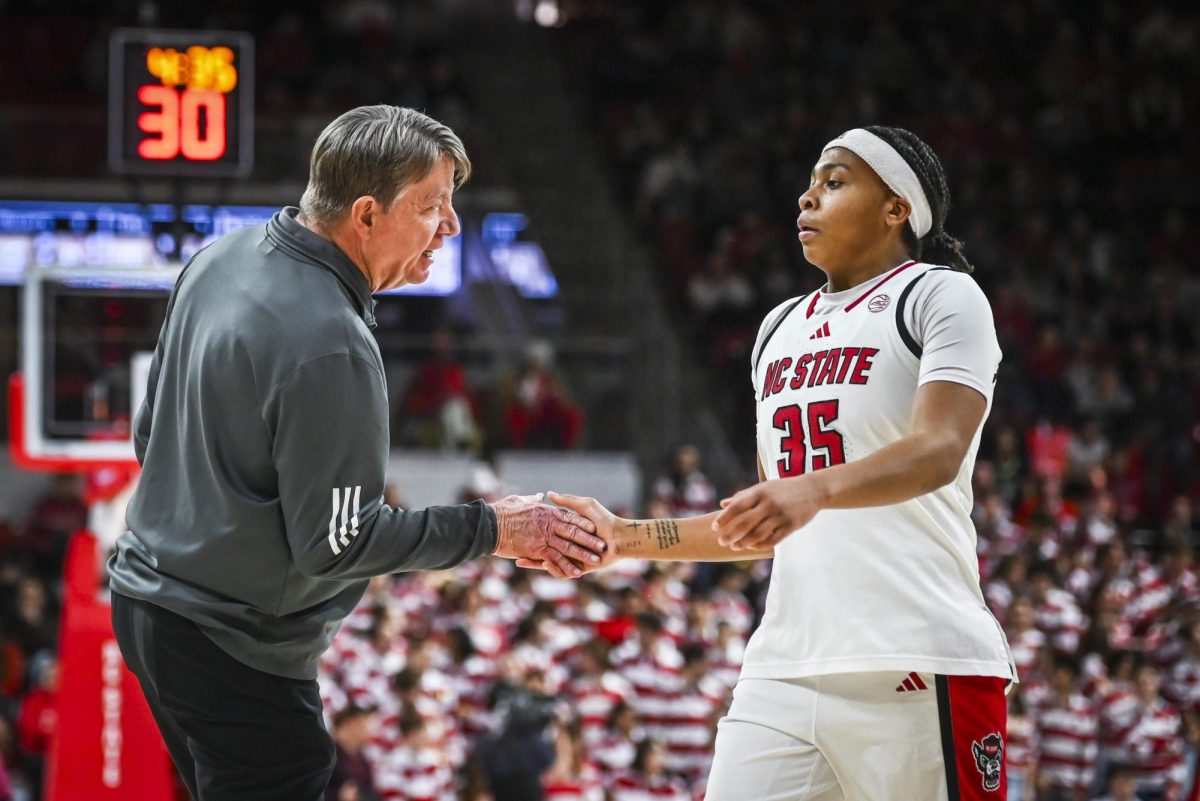 NC State head coach Wes Moore and junior guard Zoe Brooks shake hands during the game against Florida State at Reynolds Coliseum on Thursday, Feb. 5, 2026. Brooks scored 14 points. The Wolfpack defeated the Seminoles 83-55.