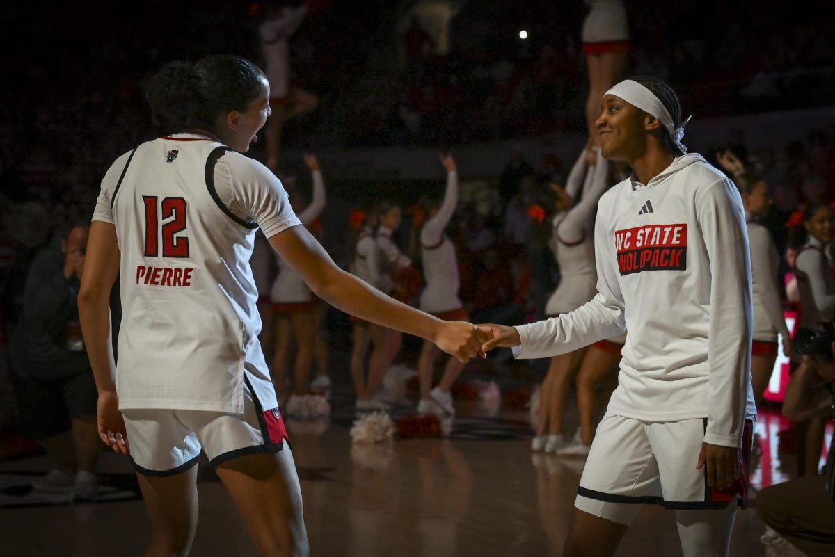 NC State junior forward Khamil Pierre and freshman guard Ky'She Lunan handshake during starting lineup introductions before the game against Florida State at Reynolds Coliseum on Thursday, Feb. 5, 2026. The Wolfpack defeated the Seminoles 83-55.
