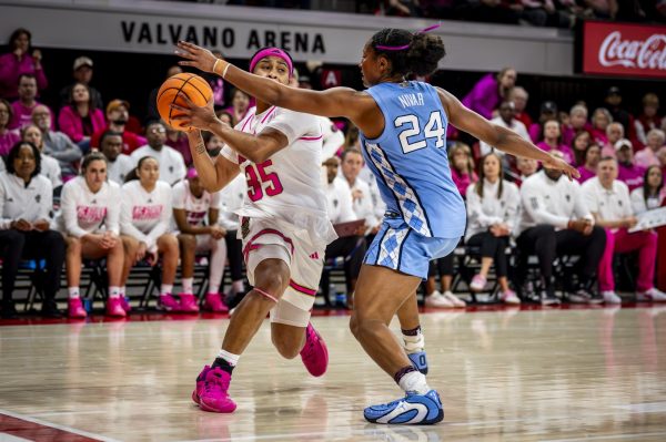 NC State junior guard Zoe Brooks (35) is defended by UNC senior guard Indya Nivar (24) during the Play4Kay game in Reynolds Coliseum on Monday, Feb. 2, 2026. The Tar Heels defeated the Wolfpack 61-59.
