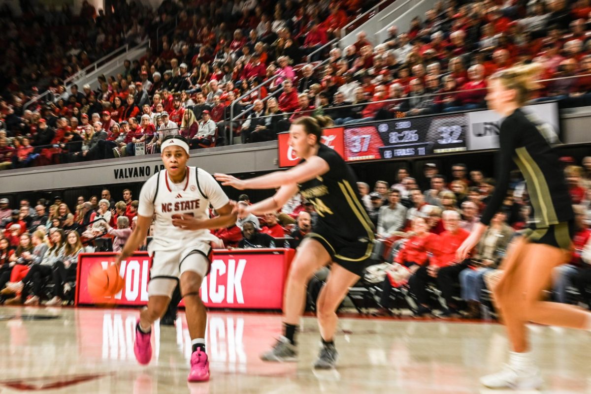 Junior guard Zoe Brooks dribbles past defenders during the game against Wake Forest at Reynolds Coliseum on Thursday, Feb. 26, 2026. Brooks scored 17 points. The Wolfpack defeated the Demon Deacons 65-56.