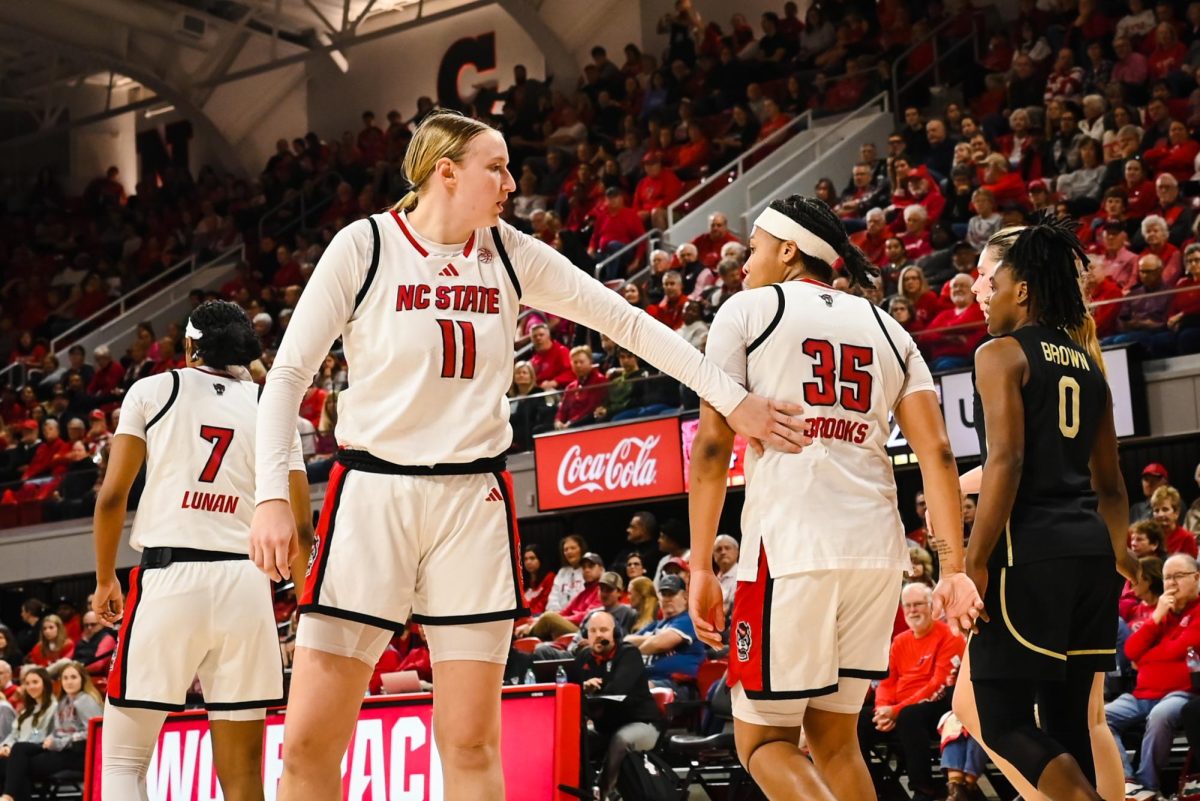 Junior forward Maddie Cox pats junior guard Zoe Brooks during the game against Wake Forest at Reynolds Coliseum on Thursday, Feb. 26, 2026. Cox and Brooks scored a combined 20 points. The Wolfpack defeated the Demon Deacons 65-56.