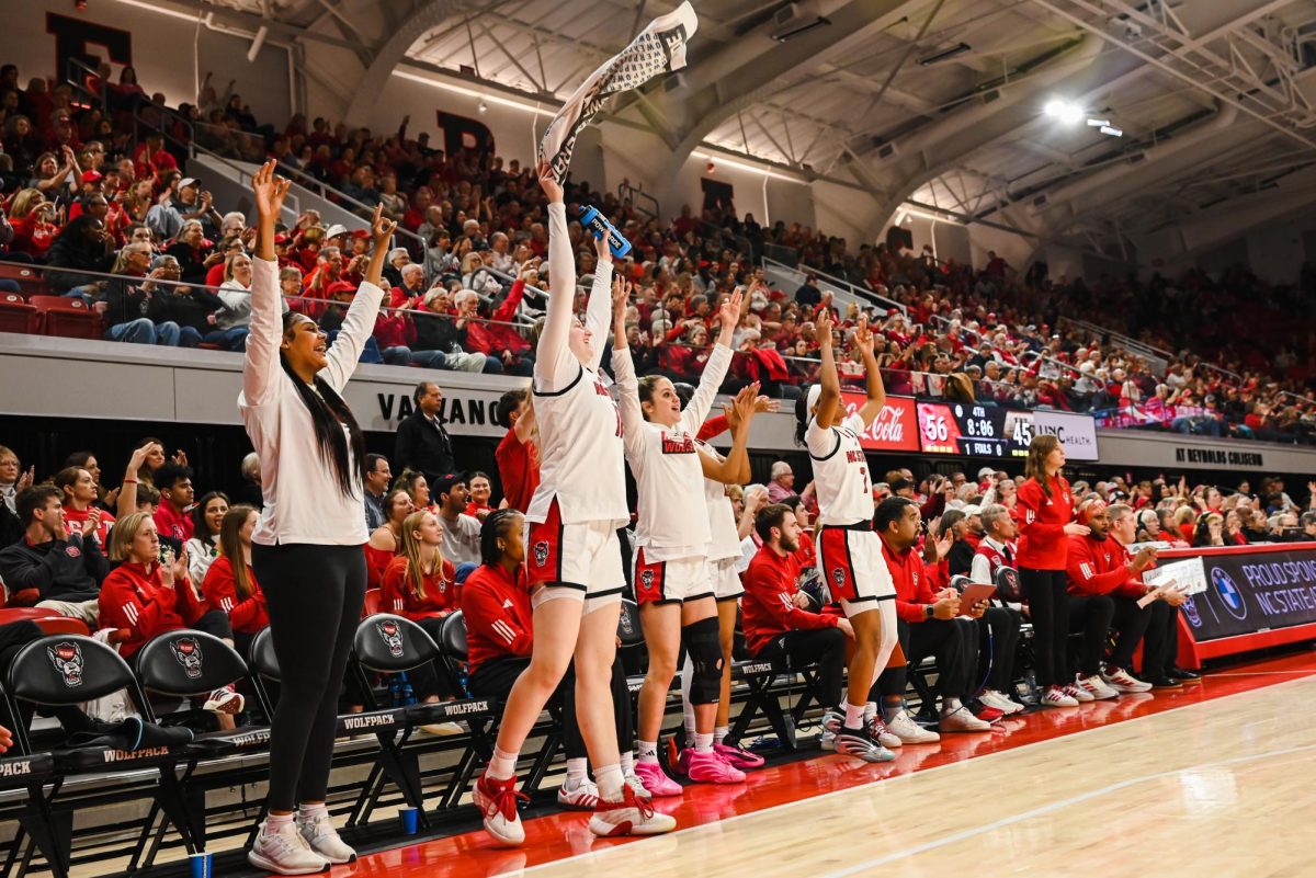 NC State players celebrate during the game against Wake Forest at Reynolds Coliseum on Thursday, Feb. 26, 2026. The Wolfpack defeated the Demon Deacons 65-56.