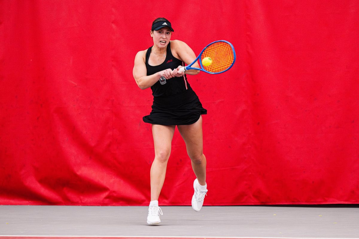 Senior Anna Zyryanova hits the back out of the air during the match against Florida inside the J.W. Isenhour Tennis Center on Tuesday, Jan. 27, 2026. Zyryanova won her singles match 6-3,4-6,7-5. The Wolfpack won against the Gators 4-3. 