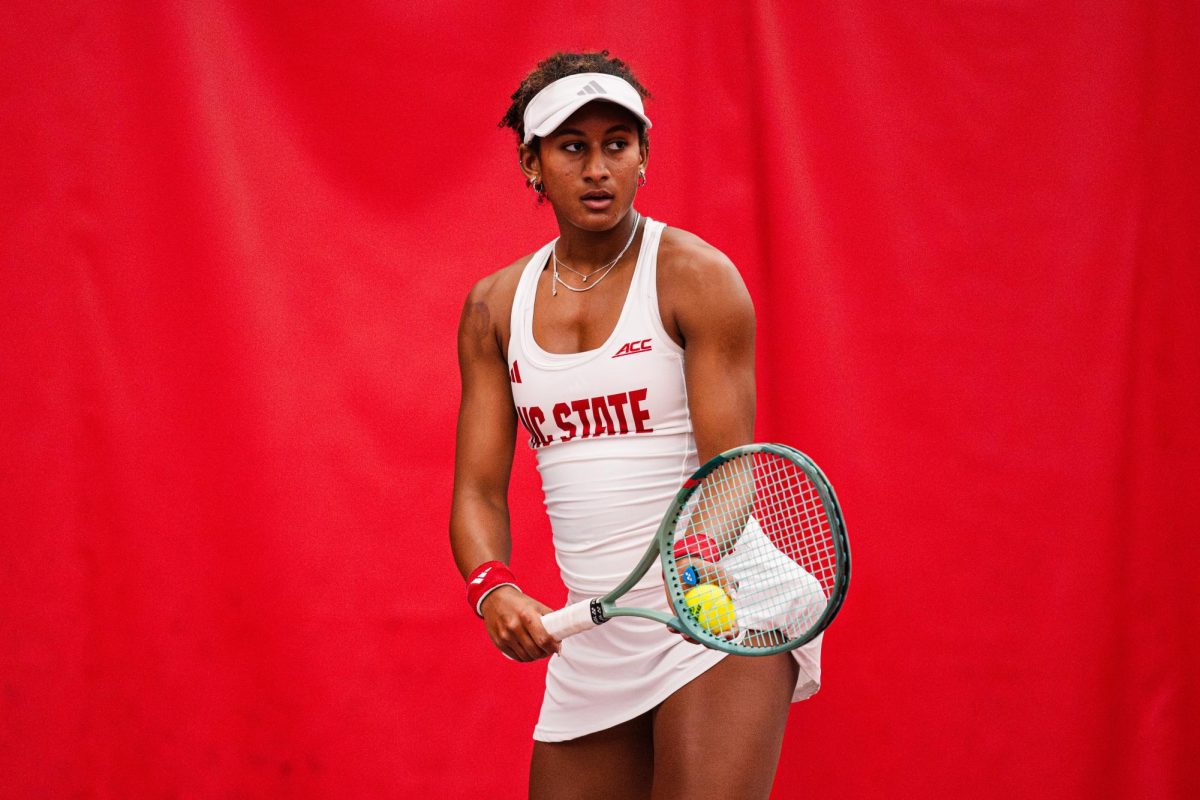 Freshman Victoria Osuigwe prepares to serve the ball during the match against UNCG inside the J.W. Isenhour Tennis Center on Tuesday, Jan. 18, 2026. Osuigwe won her singles match 6-0,6-1. The Wolfpack won against the Spartans 7-0. 