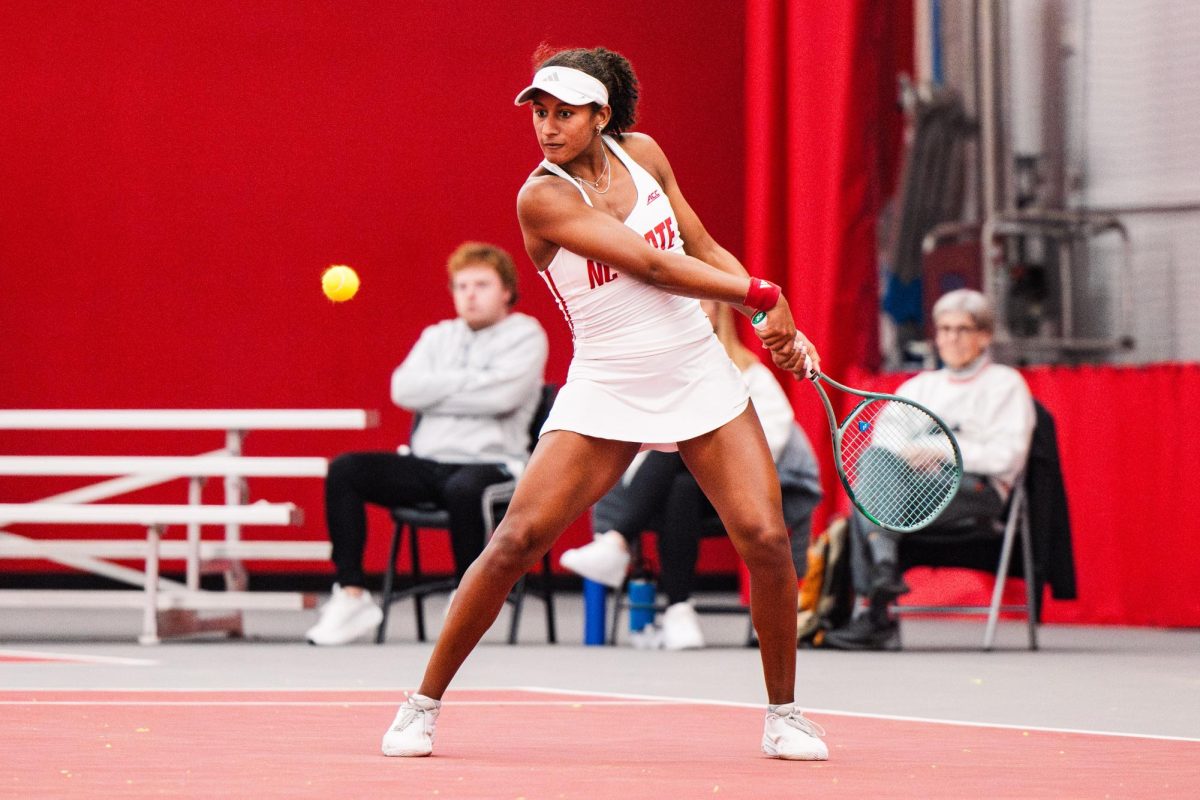 Freshman Victoria Osuigwe waits before hitting the ball during the match against UNCG inside the J.W. Isenhour Tennis Center on Tuesday, Jan. 18, 2026. Osuigwe won her singles match 6-0,6-1. The Wolfpack won against the Spartans 7-0.