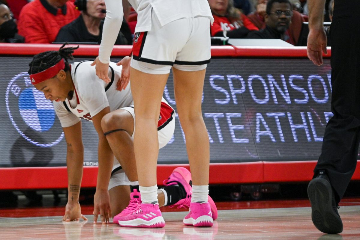 Junior guard Zoe Brooks was knocked down during the game against Syracuse at Reynolds Coliseum on Sunday, Feb. 22, 2026.  Brooks scored 20 points. NC State beat Syracuse 82-69.