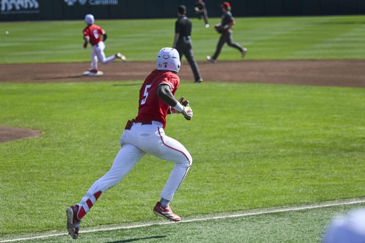 Junior infielder Sherman Johnson sprints to first during the game against Sacred Heart in Doak Field in Dail Park on Sunday, March 1, 2026. Johnson recorded three RBIs. The Wolfpack defeated the Pioneers 13-0.