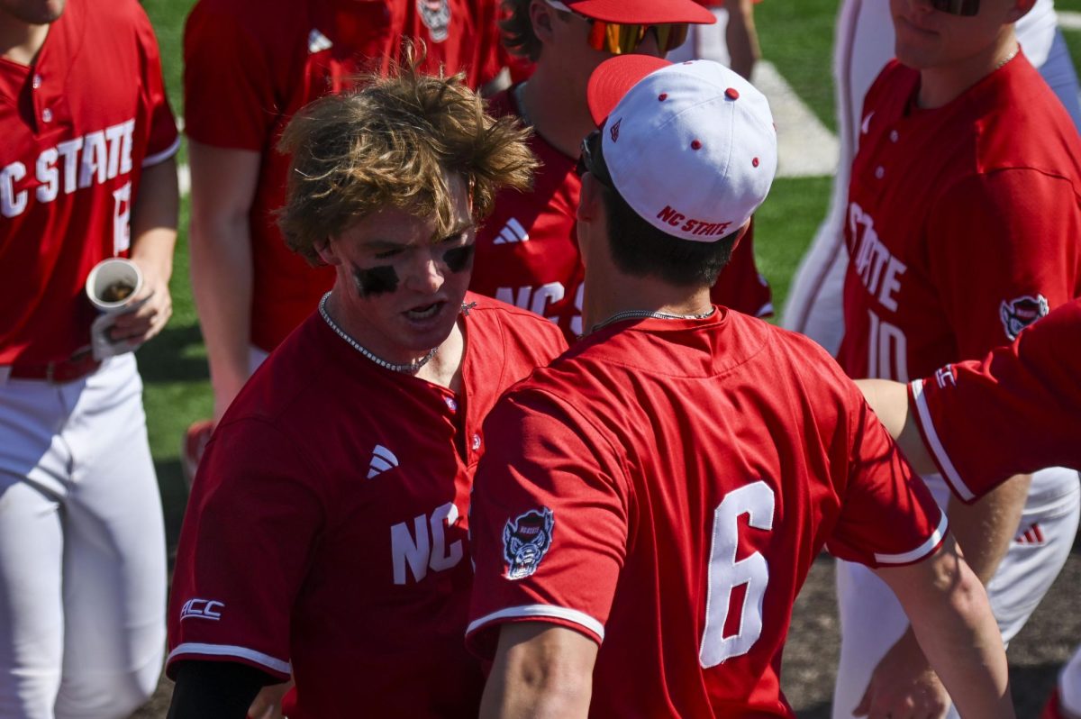 Junior second-baseman Luke Nixon and senior first-baseman Dalton Bargo chest bump after Nixon's homer during the game against Sacred Heart in Doak Field in Dail Park on Sunday, March 1, 2026. Nixon recorded three RBIs. The Wolfpack defeated the Pioneers 13-0.