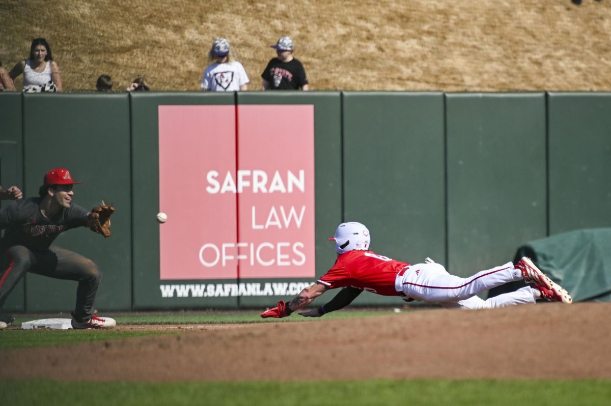 Junior second-baseman Luke Nixon dives into third during the game against Sacred Heart in Doak Field in Dail Park on Sunday, March 1, 2026. The Wolfpack defeated the Pioneers 13-0.