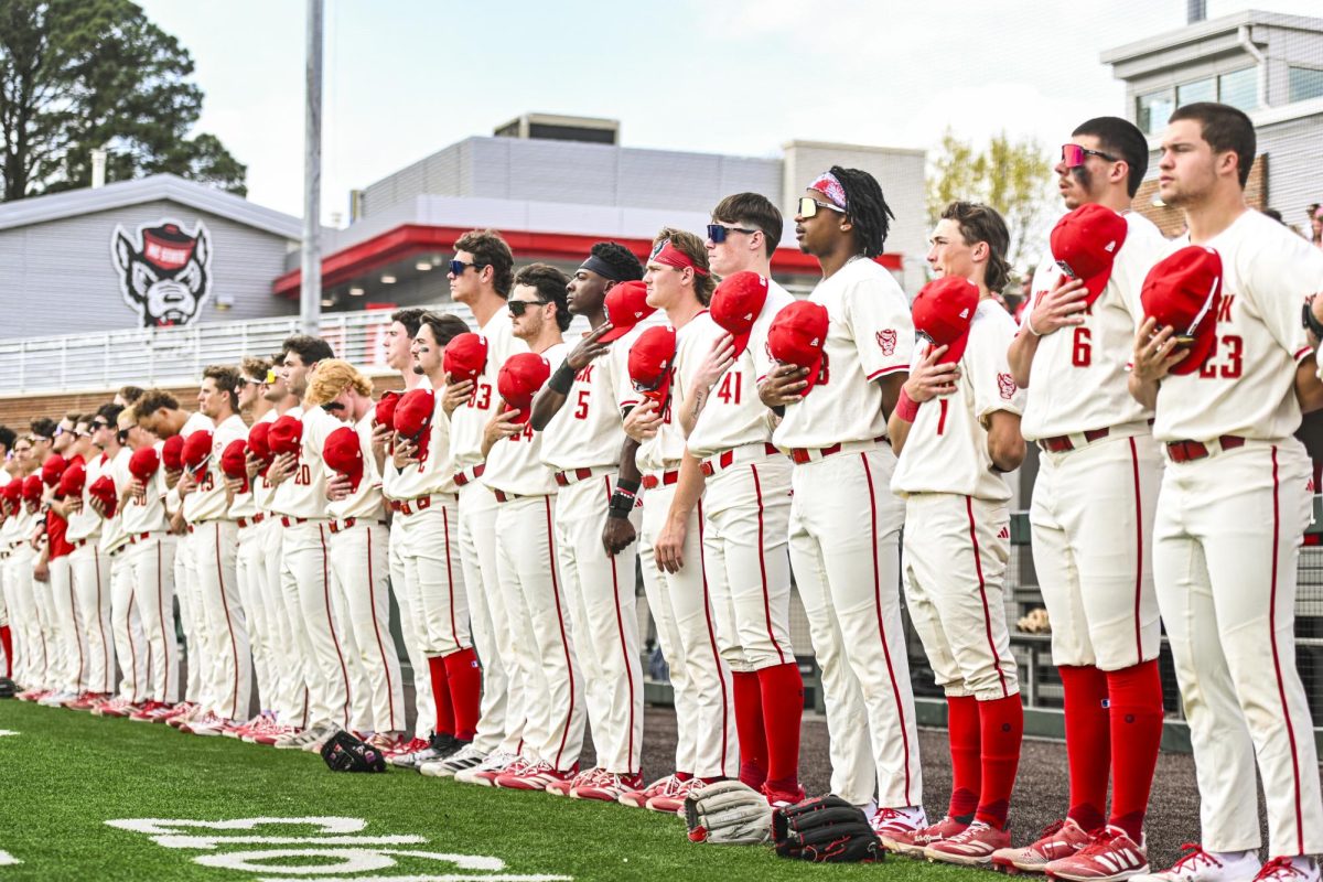 NC State baseball players stand for the playing of the national anthem during the game against Boston College at Doak Field at Dail Park on Sunday, March 15, 2026. NC State beat Boston College 5-1.