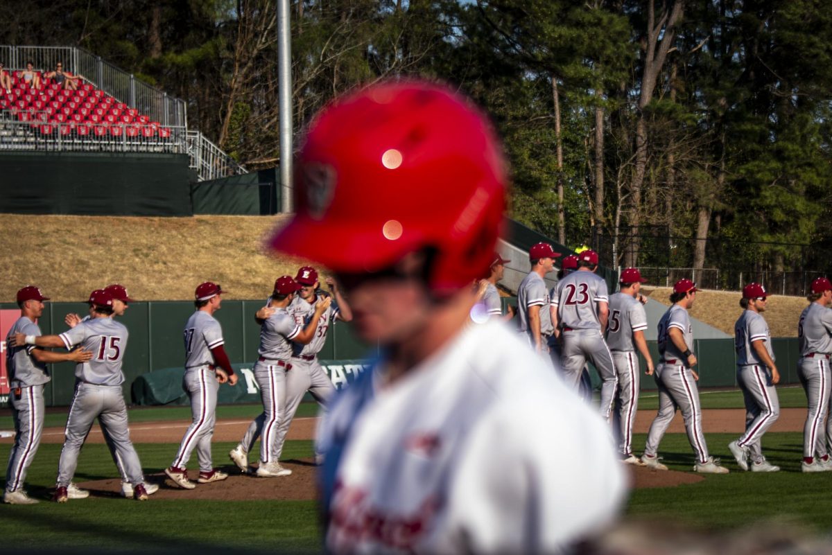 Junior infielder Luke Nixon walks to the dugout as Elon celebrates on the field after the game in Doak Field at Dail Park on Tuesday, March 10, 2026. The Phoenix defeated the Wolfpack 2-0.