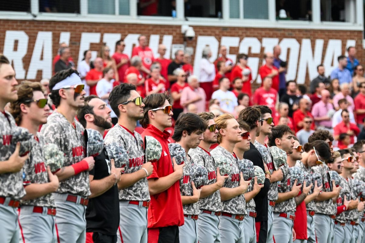 The NC State baseball team lines up for the national anthem before the Wolfpack's game against the James Madison Dukes in the NCAA Raleigh Regional final on Doak Field at Dail Park on Sunday, June 2, 2024. NC State most recently hosted the Raleigh Regional in Doak Field at Dail Park in 2024, the sixth time in the history of the ballpark.