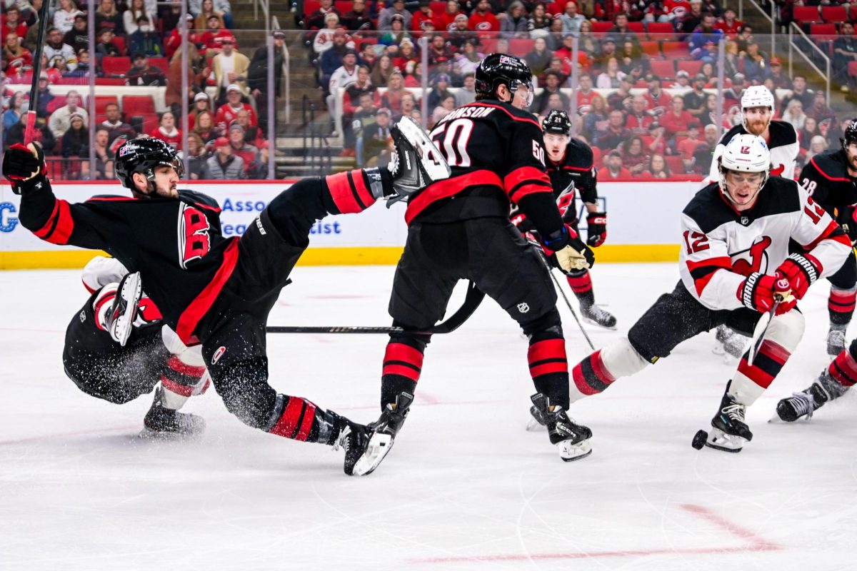 Defenseman Shayne Gostisbehere collides with an opposing player during the game versus the New Jersey Devils at the Lenovo Center on Saturday, March 28, 2026. The Canes beat the Devils 5-2.