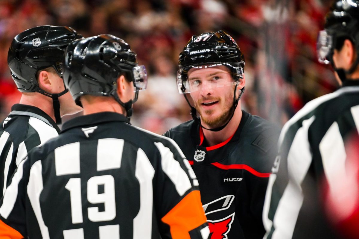 Right wing Andrei Svechnikov looks out at three officials preventing a fight between him and defenseman Dougie Hamilton during the game versus the New Jersey Devils at the Lenovo Center on Saturday, March 28, 2026. The Canes beat the Devils 5-2.