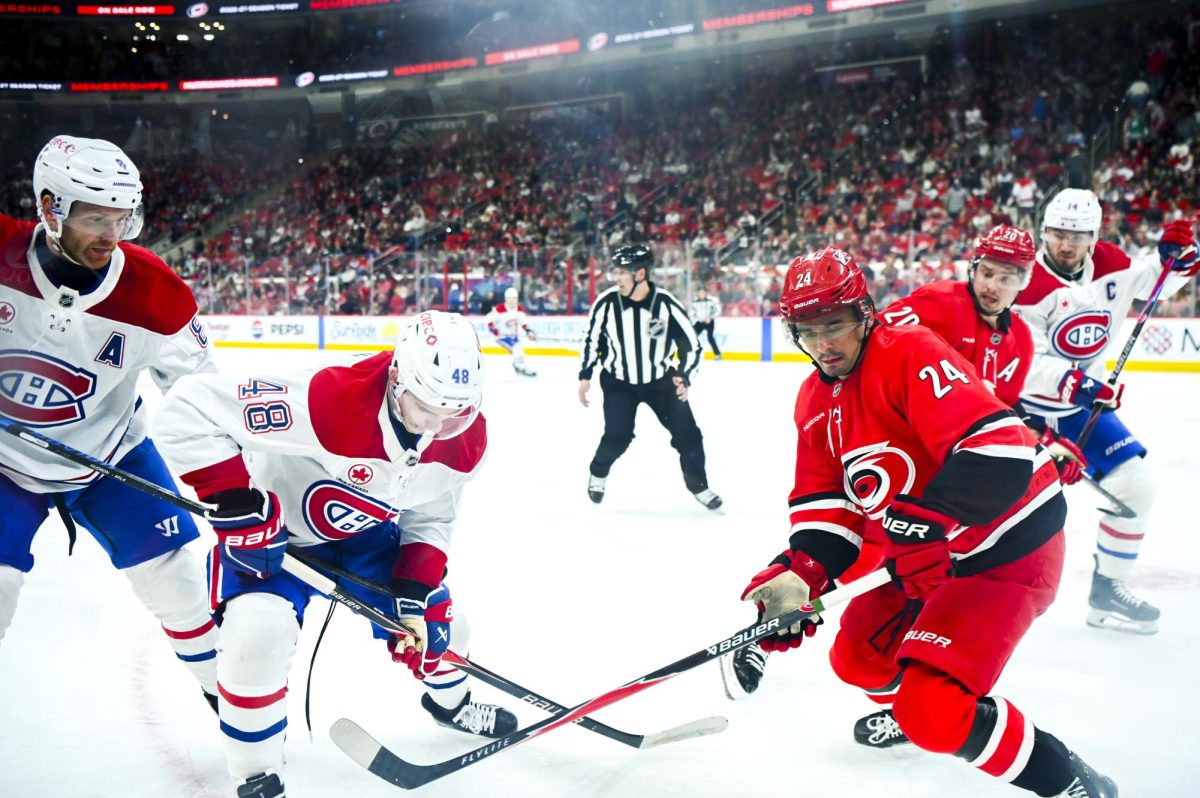 Centers Seth Jarvis and Sebastian Aho battle opponents for the puck during the game versus the Montreal Canadiens at the Lenovo center on Sunday, March 29, 2026. The Canadiens beat the Hurricanes 3-1.