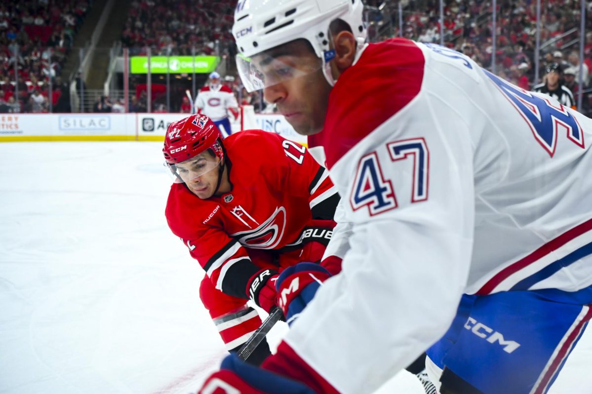 Center Logan Stankoven battles an opponent for the puck during the game versus the Montreal Canadiens at the Lenovo center on Sunday, March 29, 2026. The Canadiens beat the Hurricanes 3-1.