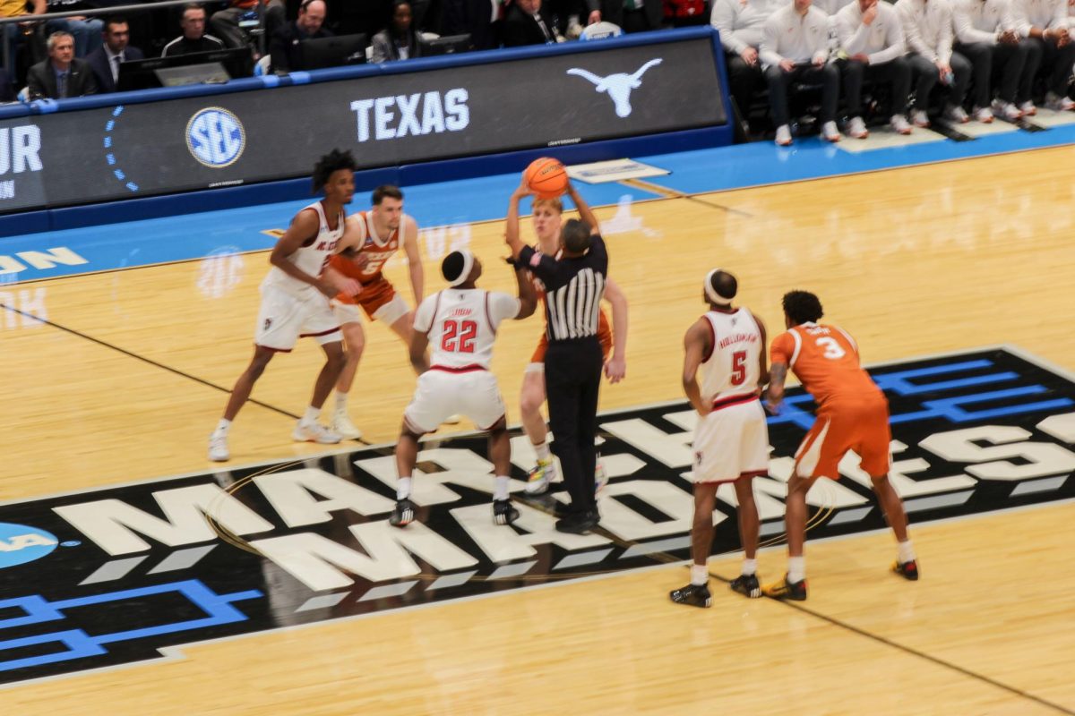 Senior forward Ven-Allen Lubin participates in the tip-off during the game against Texas at UD Arena in Dayton, Ohio on Tuesday, March 17, 2026. This is the second meet between NC State and Texas during the 2026 season. NC State lost to Texas 68-66.