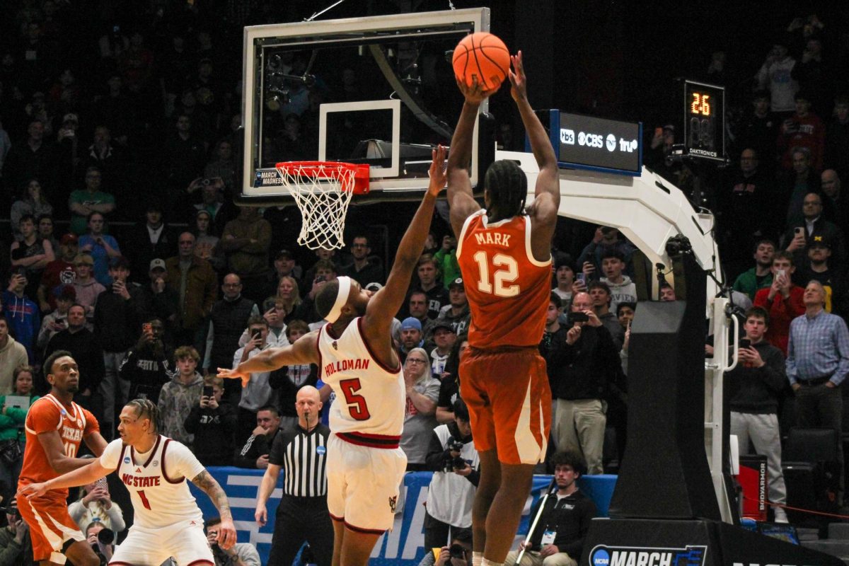 Senior guard Tre Holloman attempts to block a shot during the game against Texas at UD Arena in Dayton, Ohio on Tuesday, March 17, 2026.  Holloman had four assists. NC State lost to Texas 68-66.