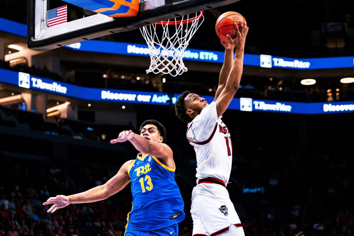 Senior guard Quadir Copeland does a reverse slam dunk during the game against Pitt in the Spectrum Center on Wednesday, March 11, 2026. Copeland led in scoring with 24 points and also added a game-high eight assists. The Wolfpack defeated the Panthers 98-88.