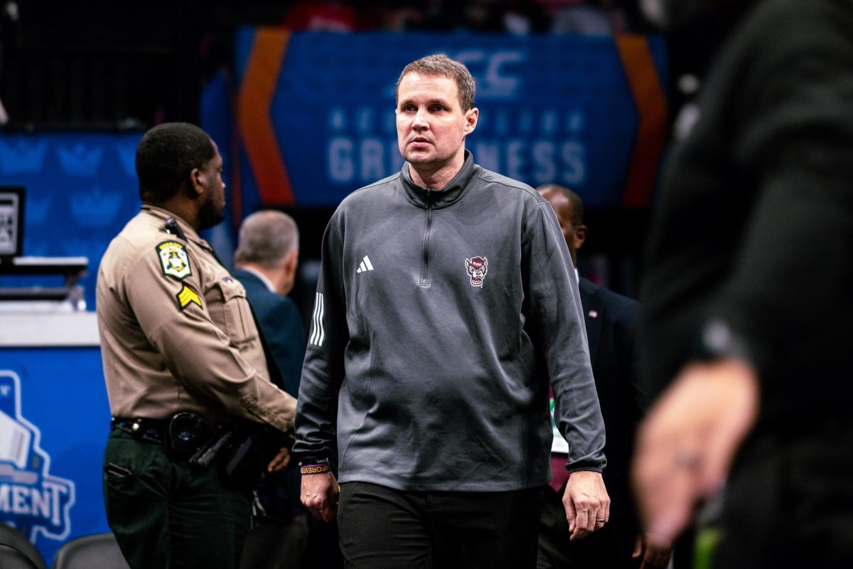 The NC State Head Coach Will Wade enters the court before the game against Virginia in the Spectrum Center on Thursday, March 12, 2026. NC State fell to Virginia 81-74.