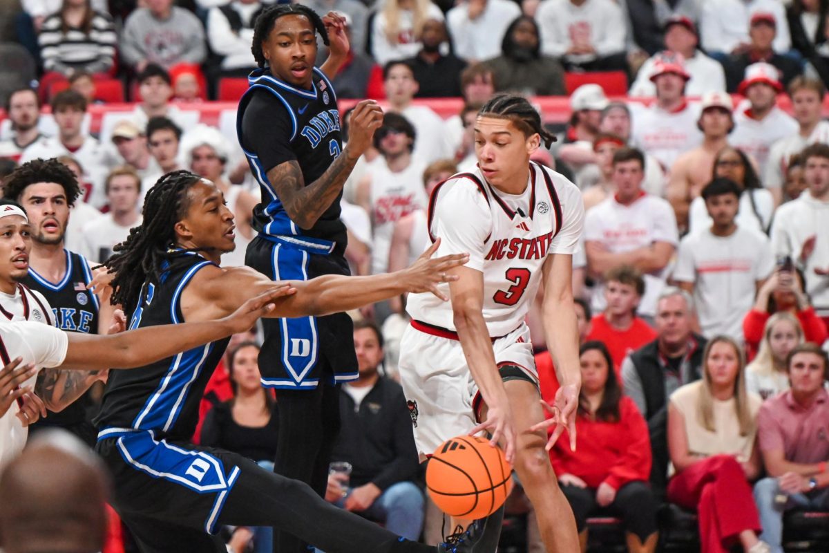 Freshman guard Matt Able passes out of his layup during the game against Duke at the Lenovo Center on Monday, March 2, 2026. The Wolfpack fell to the Blue Devils 93-64. Able finished with nine points and five rebounds. 
