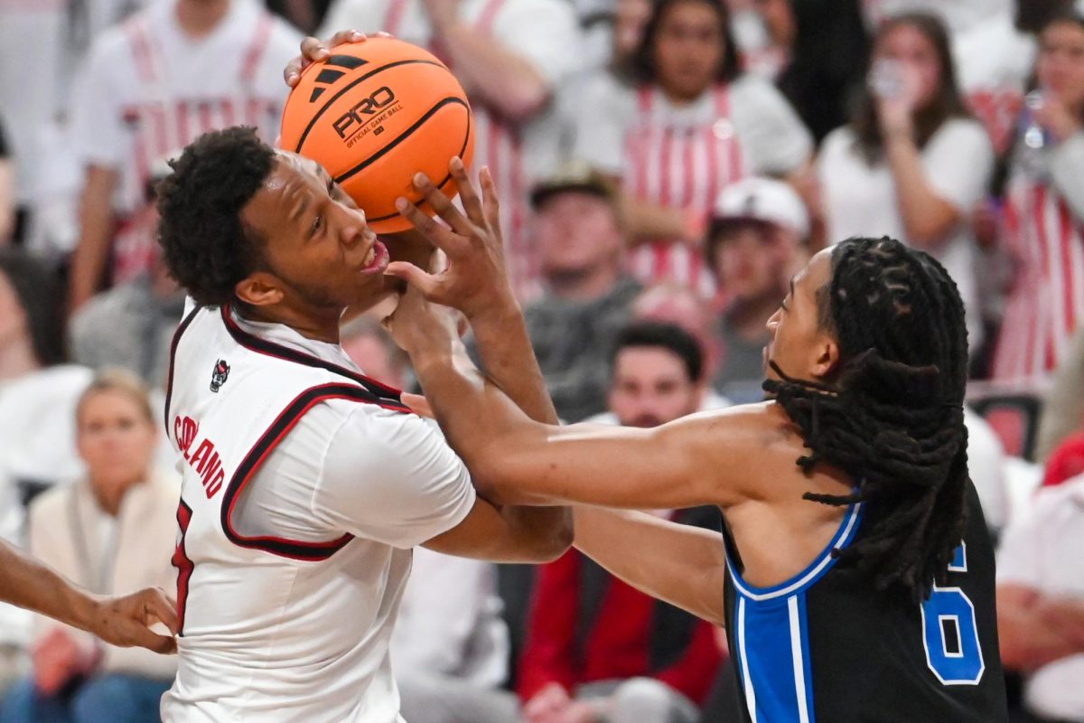 Senior guard Quadir Copeland fights through the foul during the game against Duke at the Lenovo Center on Monday, March 2, 2026. The Wolfpack fell to the Blue Devils 93-64. Copeland finished with 11 points and five assists. 
