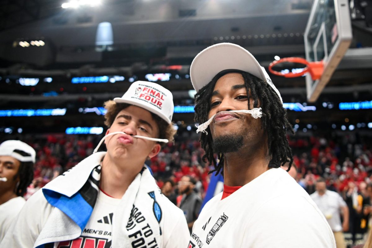 Sophomore guard Jordan Snell and junior guard Jayden Taylor wear their pieces of the net as mustaches after the NCAA Tournament Elite 8 game against Duke at American Airlines Center in Dallas on Sunday, March 31, 2024. NC State beat Duke 76-64 to advance to the Final Four.