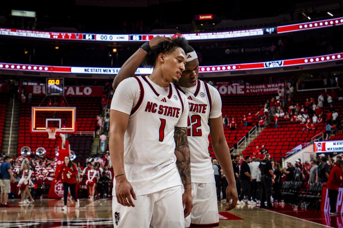 Senior forward Ven-Allen Lubin (right) consoles senior forward Darrion Williams after the game against Stanford in the Lenovo Center on Saturday, March 7, 2026. The Cardinal defeated the Wolfpack 85-84.