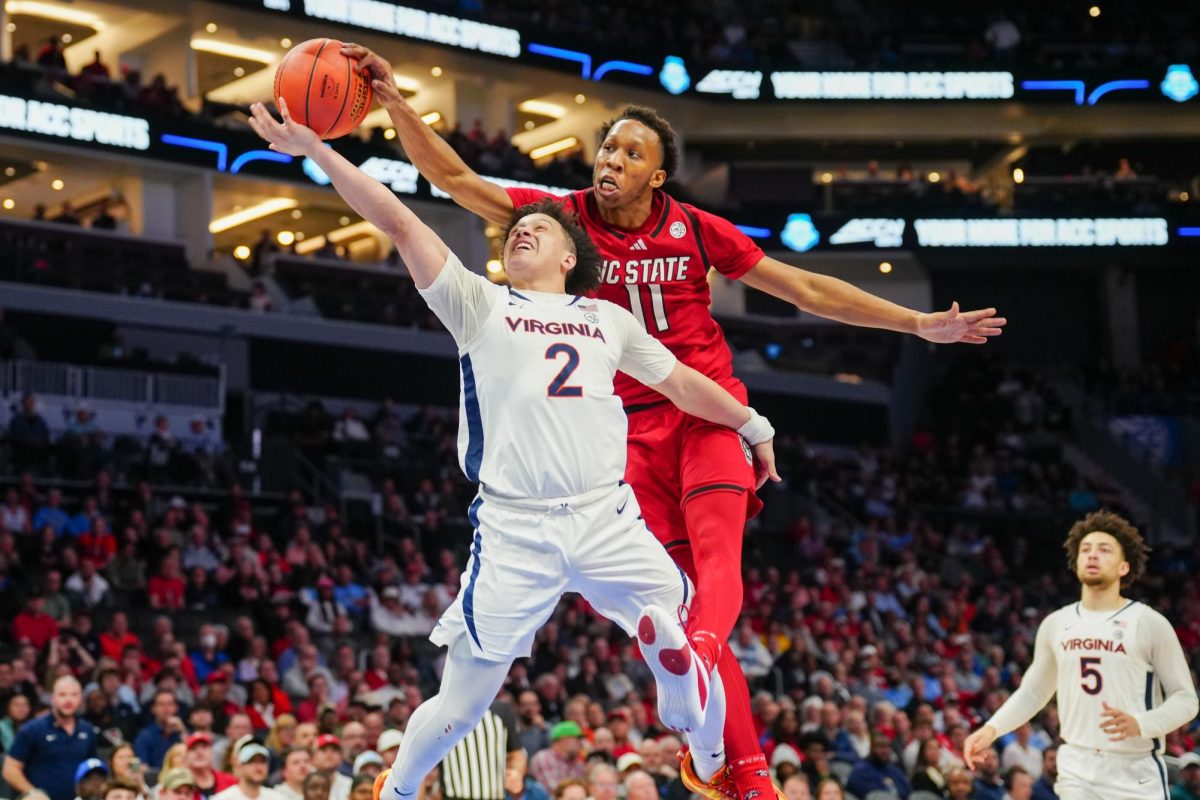 Senior guard Quadir Copeland blocks Virginia freshman guard Chance Mallory during the game against Virginia in the Spectrum Center on Thursday, March 12, 2026. Copeland had three blocks. NC State fell to Virginia 81-74.