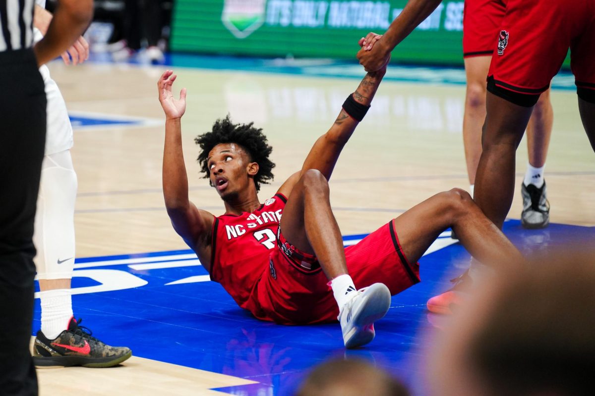 Sophomore guard Paul McNeil, Jr. looks around while getting up during the game against Virginia in the Spectrum Center on Thursday, March 12, 2026. NC State fell to Virginia 81-74.