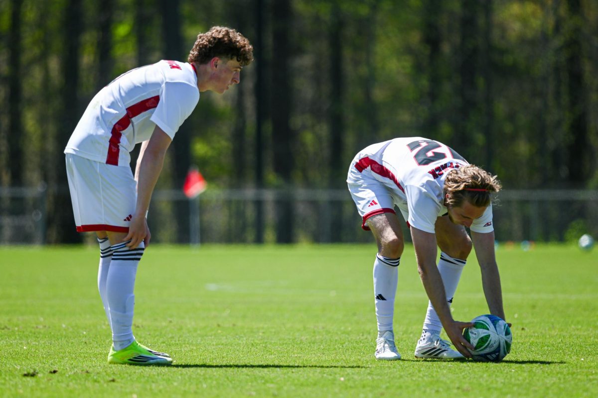 Sophomore defender Riley Moloney looks out as senior midfielder Tyler Caton positions the ball during the match against Virginia Tech at WakeMed Soccer Park on Saturday, March 28, 2026. NC State fell to Virginia Tech 1-0.