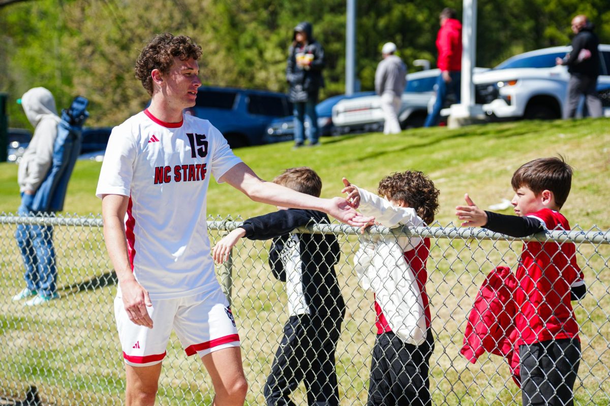 Redshirt senior forward Aidan Payne high-fives fans after the match against Virginia Tech at WakeMed Soccer Park on Saturday, March 28, 2026. NC State fell to Virginia Tech 1-0.