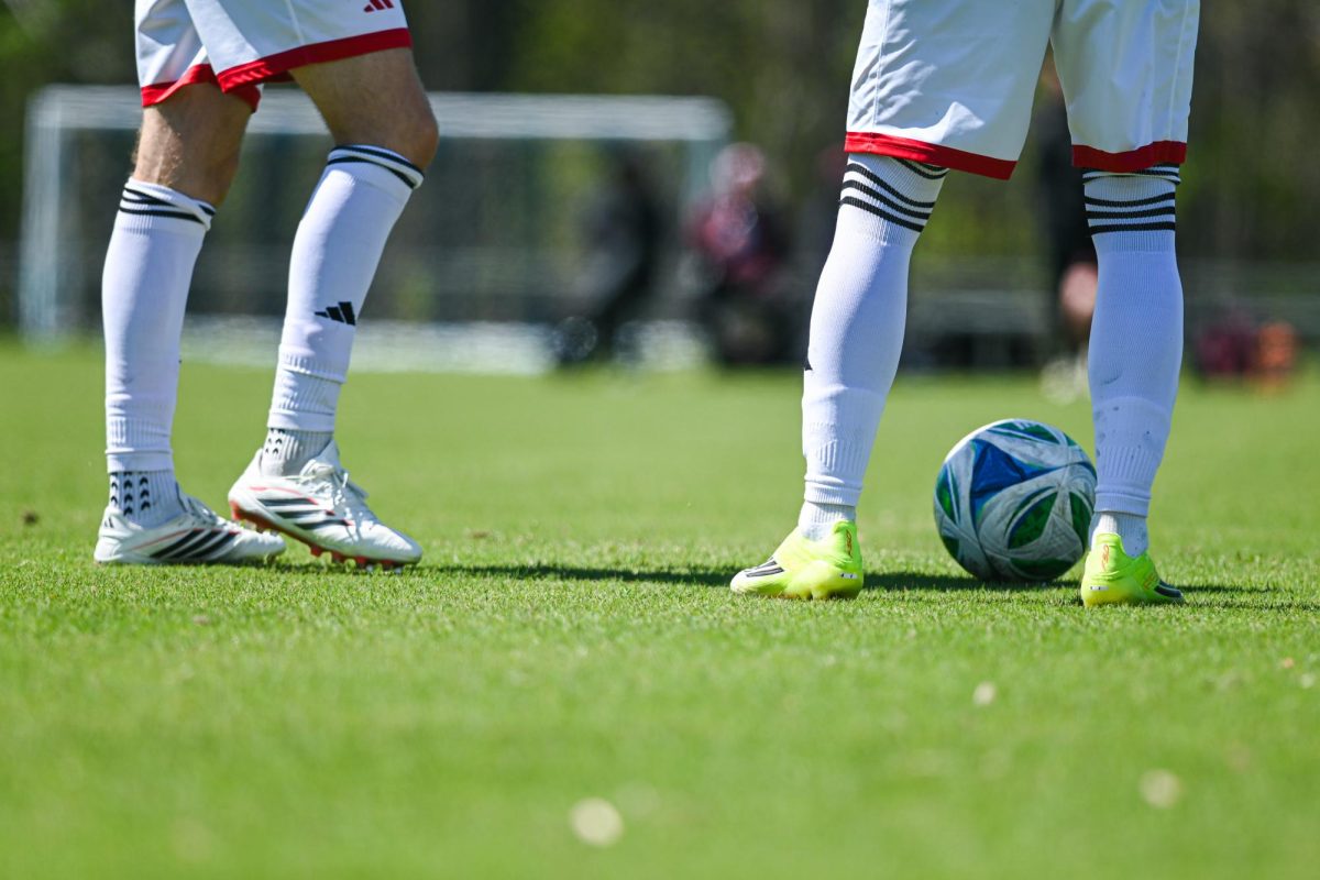 Two players stand over the ball in preparation for a free kick during the match against Virginia Tech at WakeMed Soccer Park on Saturday, March 28, 2026. NC State fell to Virginia Tech 1-0.