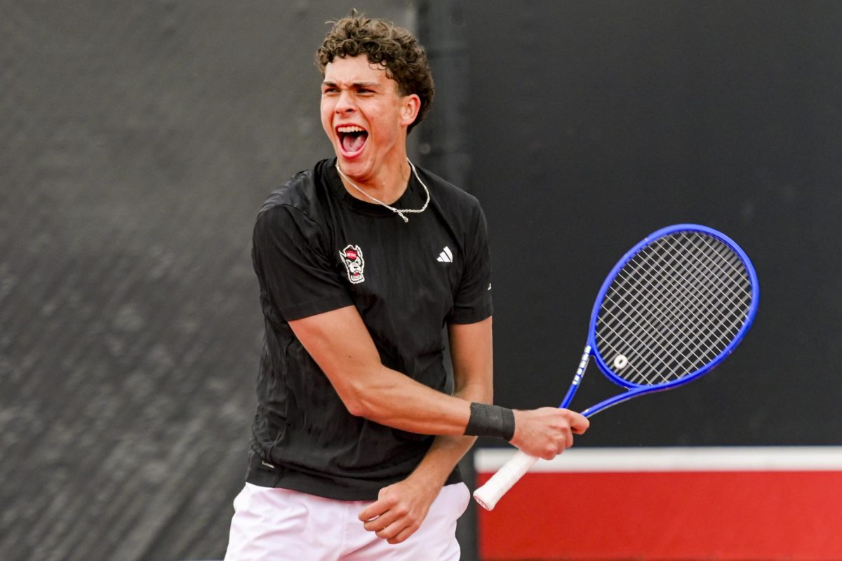 Redshirt sophomore Jules Leroux yells with pride during his doubles match with senior Martin Borisiouk during the match against Virginia at J.W. Isenhour Tennis Center on Friday, March 20, 2026. Leroux and Borisiouk lost their doubles match 6-4. NC State fell to Virginia 4-1.