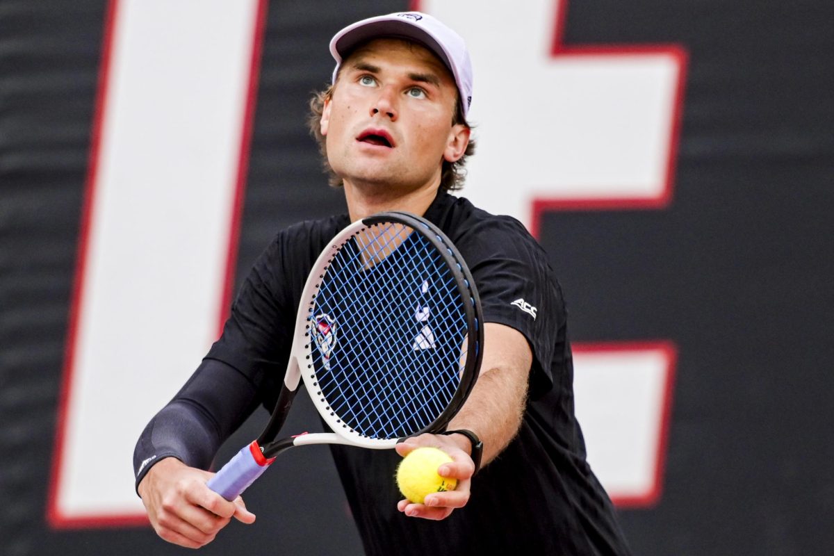 Senior Martin Borisiouk looks up, ready to serve during the match against Virginia at J.W. Isenhour Tennis Center on Friday, March 20, 2026. NC State fell to Virginia 4-1.