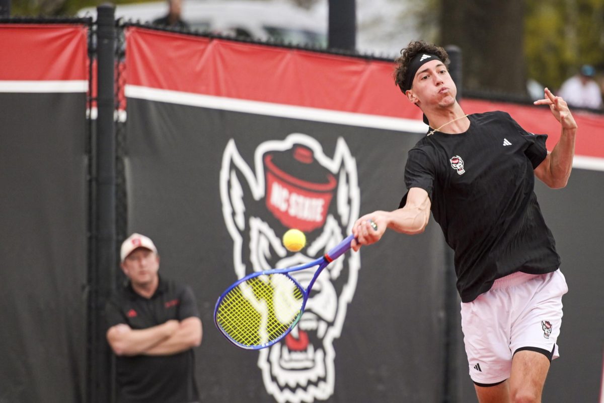 Redshirt sophomore William Manning goes for the forehand swing during the match against Virginia at J.W. Isenhour Tennis Center on Friday, March 20, 2026. NC State fell to Virginia 4-1.