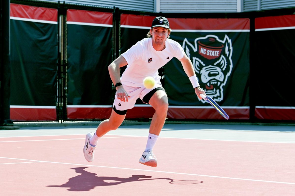 Freshman Ainius Sabaliauskas races for the ball during the match versus Clemson at J.W. Isenhour Tennis Center on Sunday, March 1, 2026. NC State beat Clemson 4-3.
