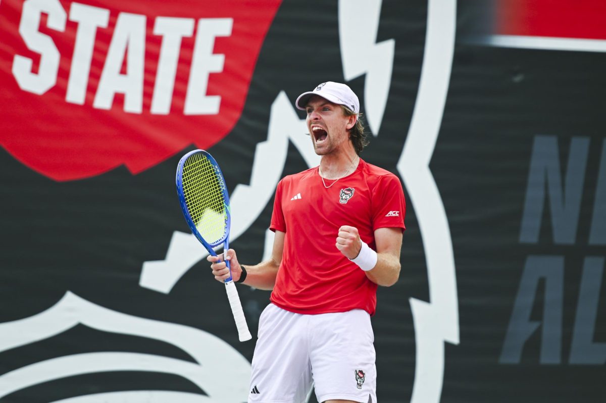 Freshman Ainius Sabaliuskas celebrates during the match versus Notre Dame at J.W. Isenhour Tennis Center on Sunday, March 15, 2026. Sabaliuskas won his singles match 2-1 (5-7, 7-6, 6-3). NC State beat Notre Dame 4-3.