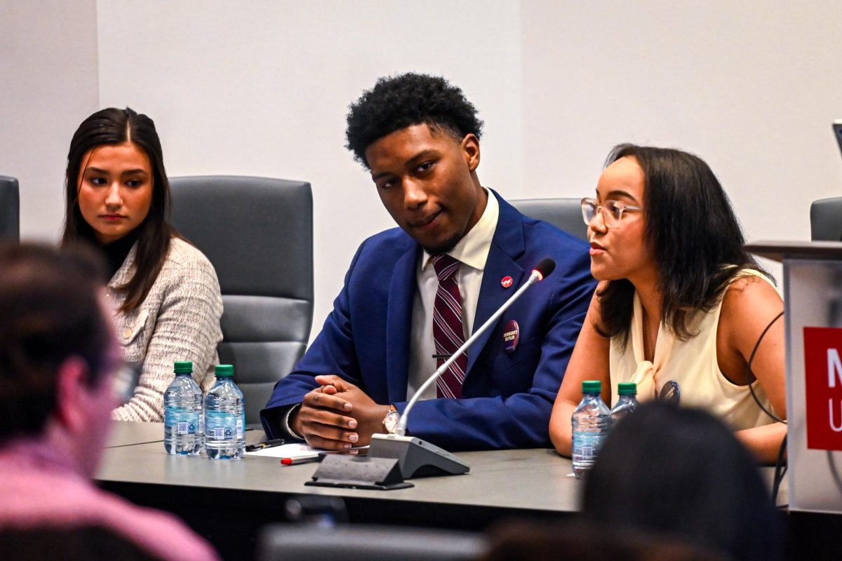 Ava Butler, a third-year studying higher education and candidate for Student Body Vice President, speaks as Taquan Dewberry, a third-year studying philosophy and applied education and candidate for Student Body President, and Hubbard Stack, a first-year in the College of Textiles and candidate for Student Body Vice President look on during the Student Government Debates in the SG Governance Chamber in Talley Student Union on Monday, March 2, 2026. 
