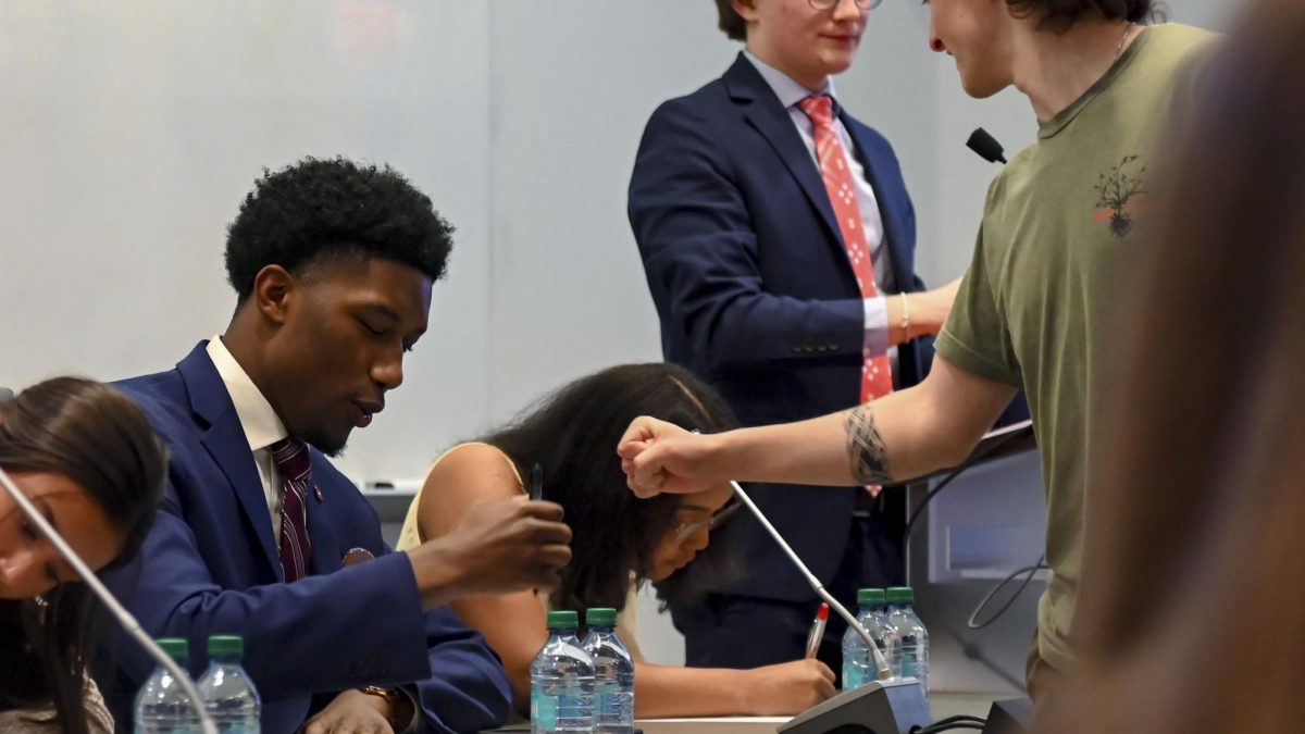 Taquan Dewberry, a third-year studying philosophy and applied education and candidate for Student Body President, first bumps a student during the Student Government Debates in the SG Governance Chamber in Talley Student Union on Monday, March 2, 2026. 