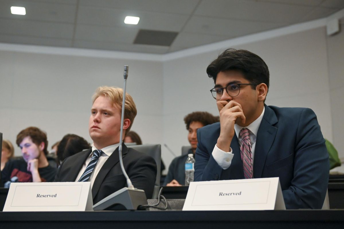 Zach Eddinger, a third-year studying political science and candidate for Student Body President, and his running partner Alexander Rivas, a third-year studying politcal science, listen to the debates ahead of theirs during the Student Government Debates in the SG Governance Chamber in Talley Student Union on Monday, March 2, 2026. 